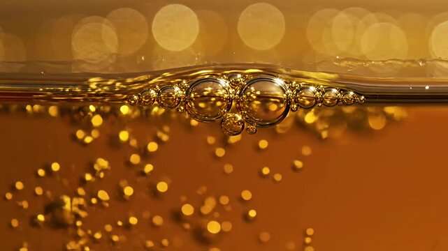Bubbles on the surface of golden liquid.