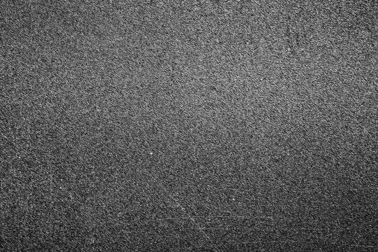 Abstract monochrome macro shot of the subtle surface of black plastic 