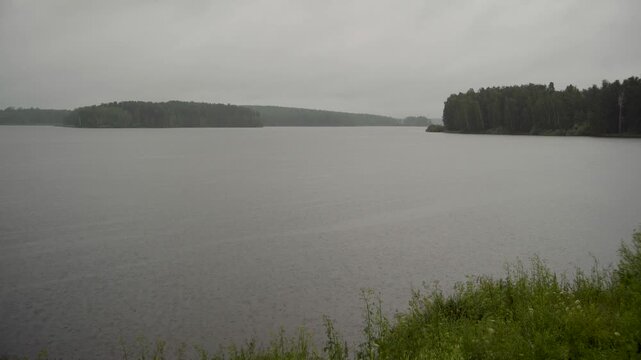 serene lake with islands and grassy foreground in natural landscape materials, static view perspective, green and gray tones, peaceful outdoor setting, nature scene, clean background.