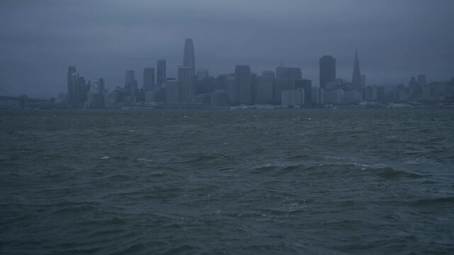 Silhouetted San Francisco Skyline Bay View, Choppy Waves And Dark Overcast
