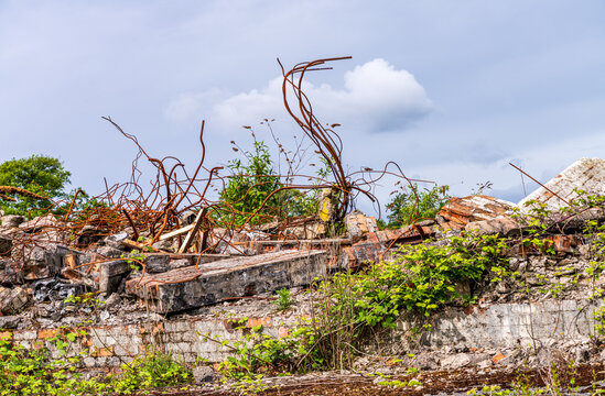 Remnants of demolished structures at Lydney Harbour in Gloucestershire, England, featuring piles of rubble and rebar.