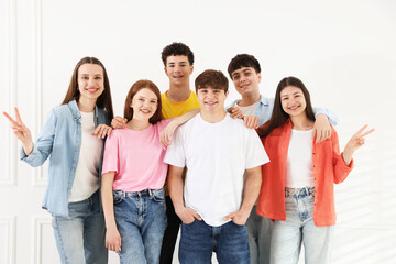 Obraz premium Portrait of happy teenagers near white wall indoors