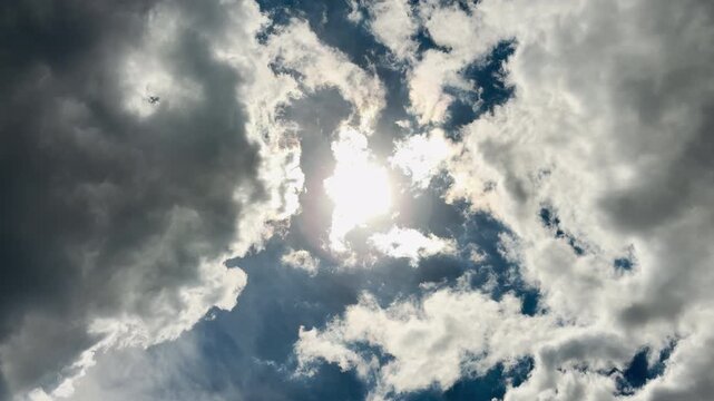 The bright sun breaks through heavy storm clouds in the dramatic sky. This powerful sight fills the viewer with a hopeful and peaceful feeling.