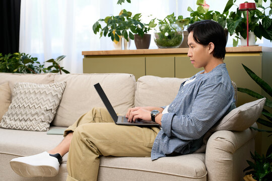Young man enjoying leisure time at home in a stylish modern apartment