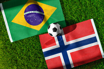 Obraz premium Brazil vs Norway, national flags before international football tournament Round of 16 match, football on green grass with stadium in the background, East Rutherford, New Jersey, USA, July 5, 2026