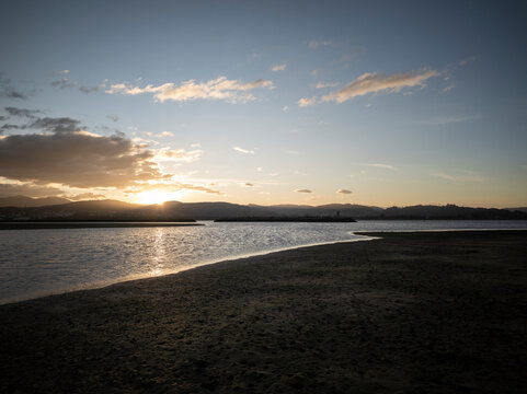 Sunset reflecting on water at beach shore