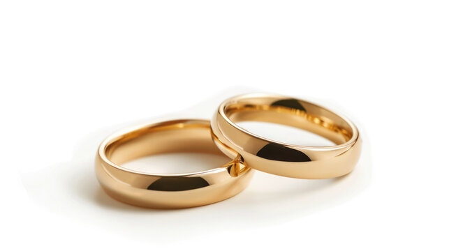 A pair of golden wedding rings isolated on a white background.