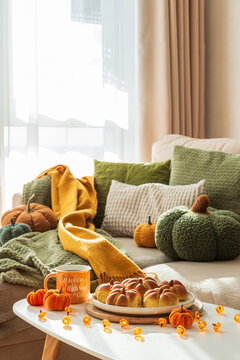 Cozy autumn pumpkin bread buns and mug on table