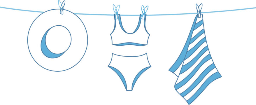 Summer beach clothing items hanging on laundry line including hat bikini and striped towel