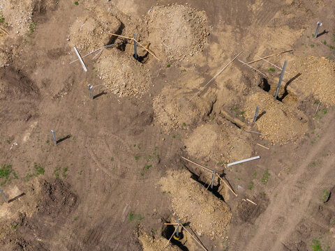 Aerial view of construction site for solar panels farm and machinery in progress