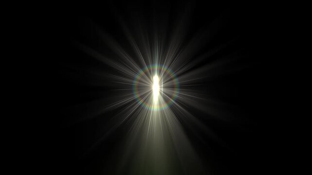 An intense bright light source creates radiant beams spreading outward in a dark environment