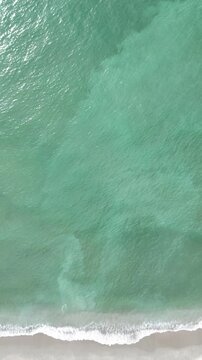 waves on the beach from a drone aerial up high sky background