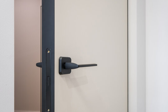 door handle on white wooden door in interior. Knob close-up elements. Door handle, fittings for interior design
