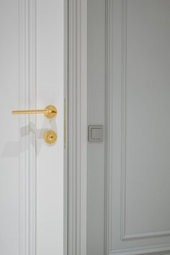 door handle on white wooden door in interior. Knob close-up elements. Door handle, fittings for interior design