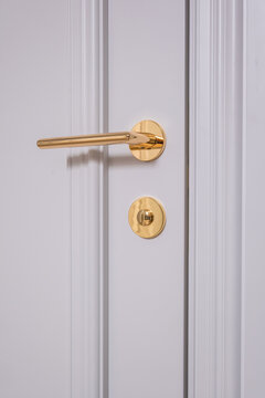 door handle on white wooden door in interior. Knob close-up elements. Door handle, fittings for interior design