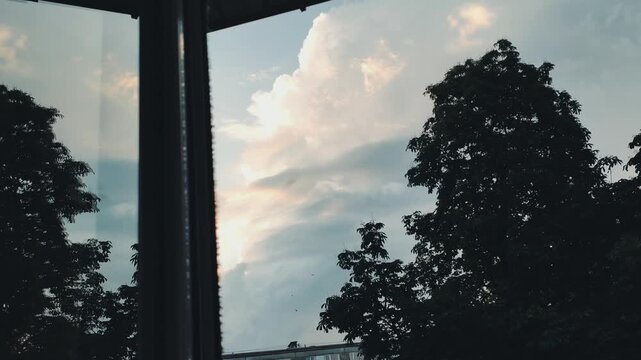 Wide view of dense gray cloud layers with diffused sunlight filtering through the overcast sky.