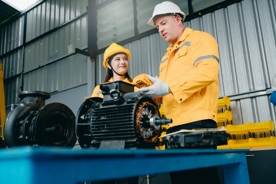 Machine inspection concept. Industrial technicians checking electric motor with diagnostic meter for preventive maintenance, equipment reliability and safety service.