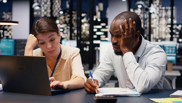 Diverse workers team being exhausted and disappointed with missing deadline, stressed and worried people struggling to finish tasks with low energy and no motivation, poor results.