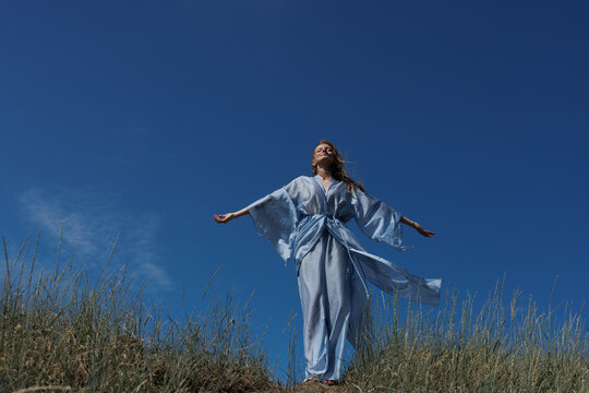 Embracing Nature: Woman Meditating in a Serene Landscape