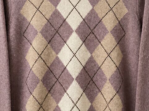 Classic argyle pattern knit sweater texture soft wool fabric background in mauve purple, beige, and cream colors