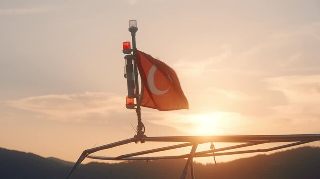 Boat signal light shines at sunset over a calm waterway with hills in the background during an evening outing near the shore
