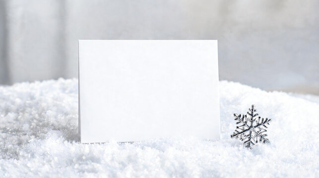Winter greeting card mockup on snow with silver snowflake ornament. Christmas invitation note card, seasonal holiday message stationary placeholder, copy space, winter, card, mock up, xmas.