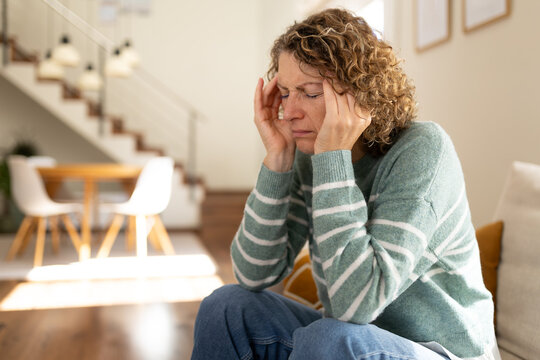 Woman suffering from headache experiencing intense migraine pain