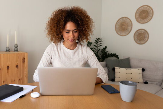Woman working remotely using laptop computer at home