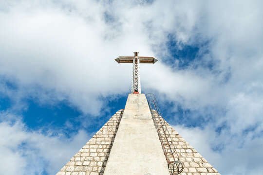 Historic military memorial cross against blue sky in Abruzzo Italy