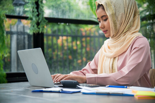 Portrait Muslim woman wear hijab smile face look at camera. Muslim women working. Muslim woman wear hijab work from home office typing laptop keyboard on wooden desk office supply happy smiling face