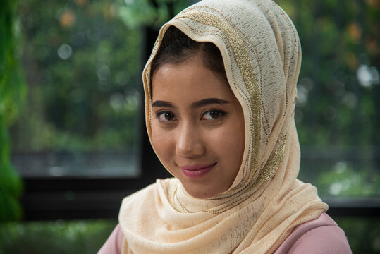 Young Asian arabian muslim women working summary report business graph chart. Crop arabian muslim women working business report graph chart. Portrait Muslim woman wear hijab smile face look at