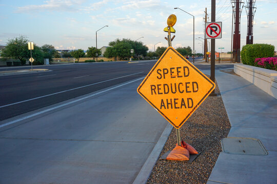 Reduced speed ahead sign on road