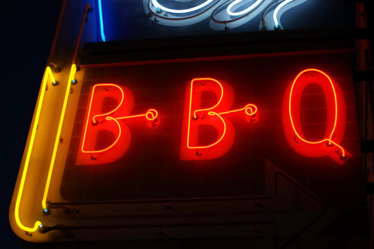 neon BBQ sign glowing at night