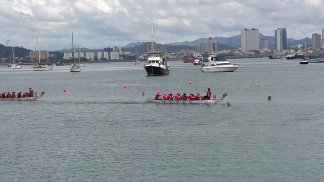Dragon Boat Race in Urban Harbor with City Skyline