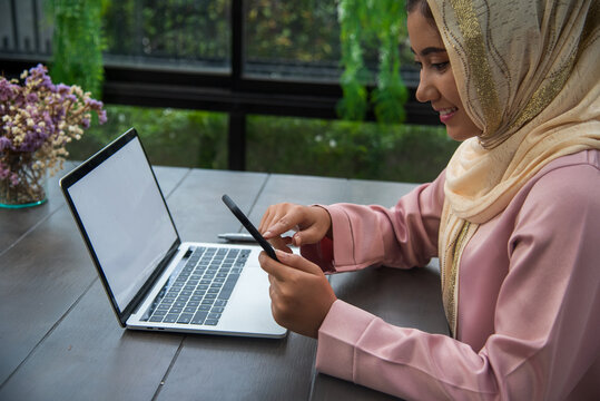 Young Asian arabian muslim women working summary report business graph chart. Crop arabian muslim women working business report graph chart. Portrait Muslim woman wear hijab smile face look at