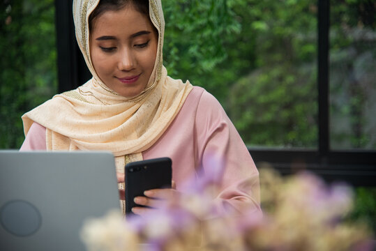 Young Asian arabian muslim women working summary report business graph chart. Crop arabian muslim women working business report graph chart. Portrait Muslim woman wear hijab smile face look at