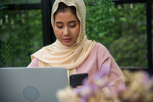 Young Asian arabian muslim women working summary report business graph chart. Crop arabian muslim women working business report graph chart. Portrait Muslim woman wear hijab smile face look at