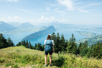 Obraz premium Hiker enjoying panoramic lake lucerne view from mount rigi