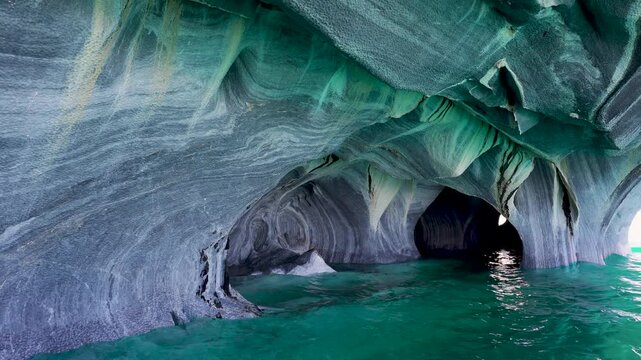 Boat-level view inside the Marble Caves, showcasing water-eroded stone walls and vibrant turquoise glacial water in General Carrera Lake, Patagonia, Chile.