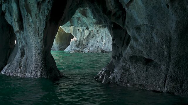 Interior view of the Marble Caves with detailed stone walls sculpted by water and vibrant turquoise water, wide shot of the iconic geological landmark in Patagonia, Chile.