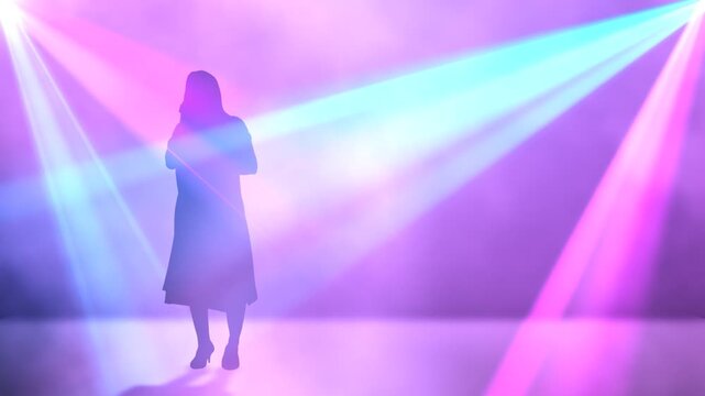 silhouette woman dancing in a nightclub with ray light effect background