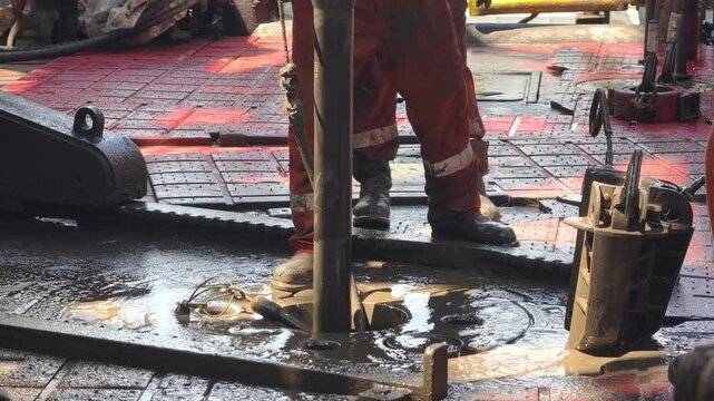 Drilling rig activity - Pull of of hole drill string with oil based mud on the rig floor. Trip out of hole.