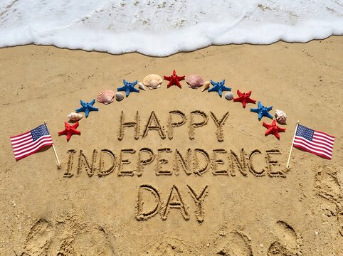 Happy independence day written in sand on a summer beach