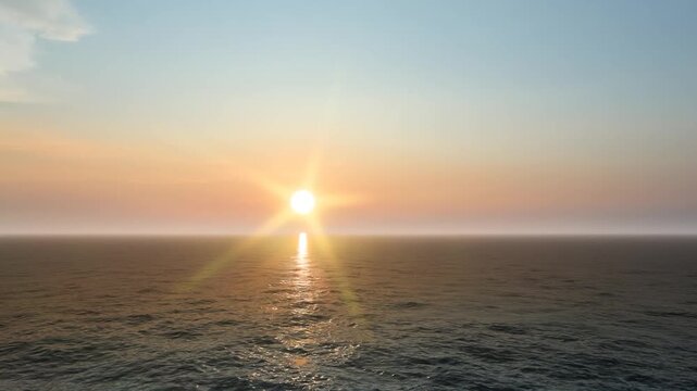 Beautiful Golden Ocean Sunrise with Calm Waves and Clear Sky