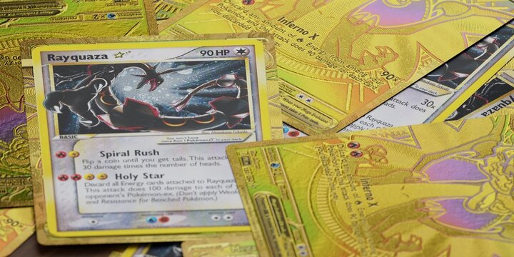 pile of gold star rayquaza and mega charizard pokemon cards, english tcg version