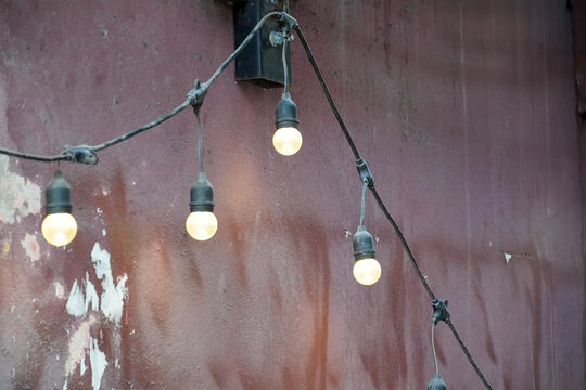 Warm decorative string lights hanging against a rustic background