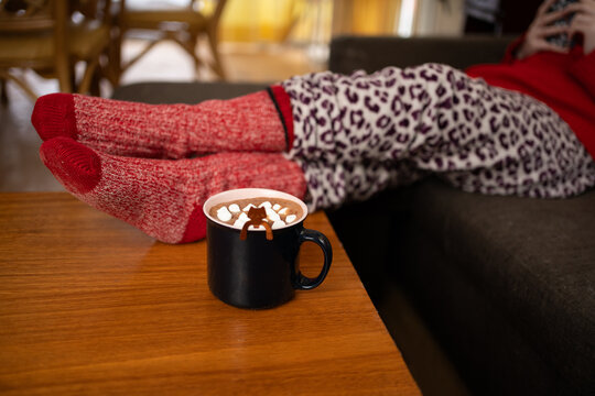 Relaxing at home with warm drink and comfortable wool socks