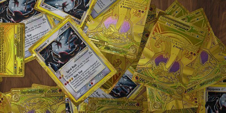 pile of gold star rayquaza and mega charizard pokemon cards, english tcg version