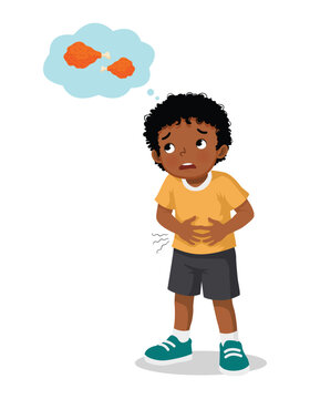 Little African boy feeling hungry thinking of eating fried chicken

