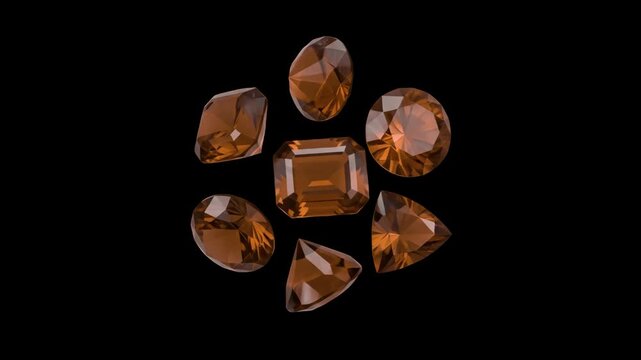 Various shapes of faceted orange gemstones spin smoothly in a tight circular cluster over a deep black background. The dark backdrop accentuates the intricate refraction and high-end luster of the cry